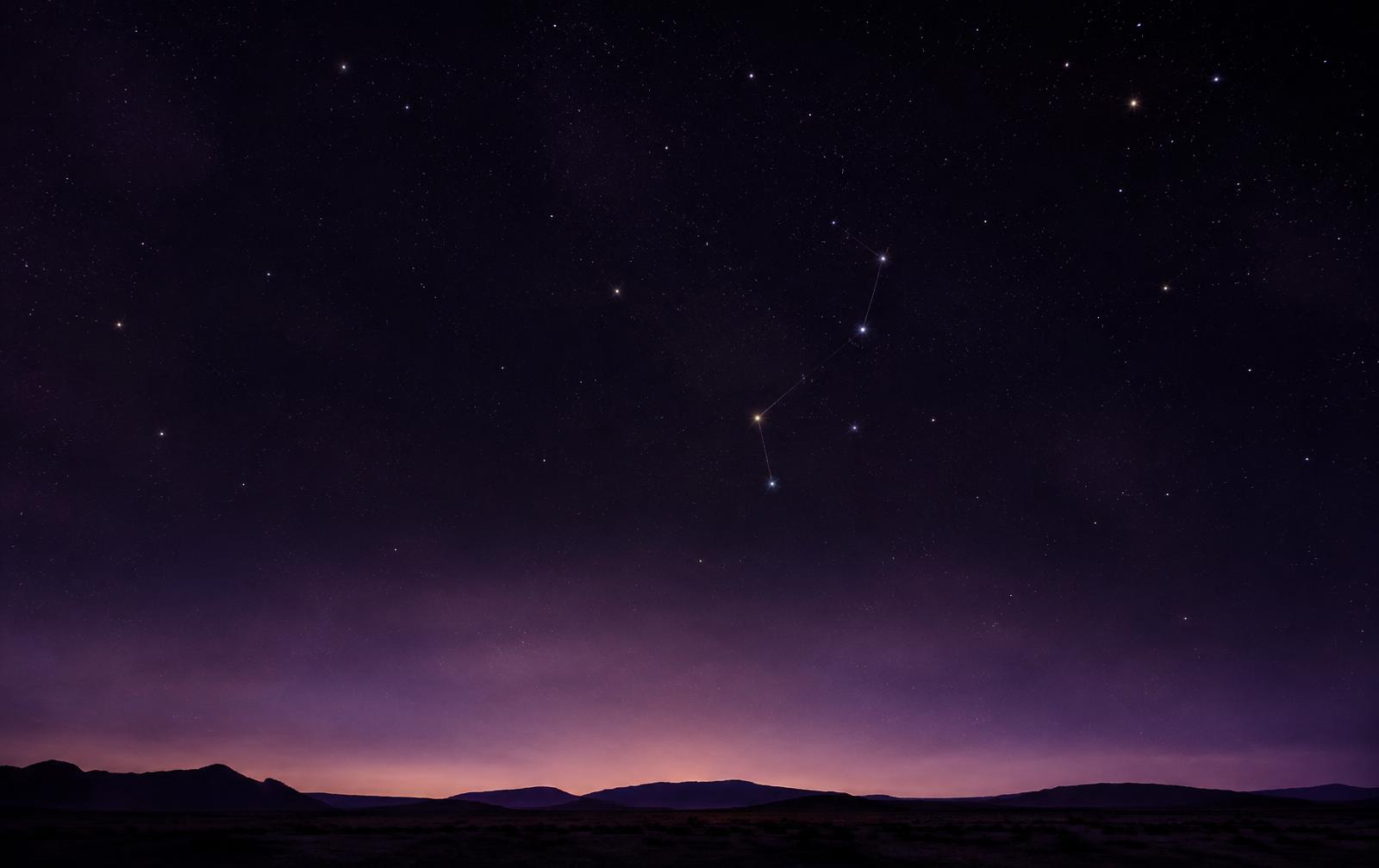 A quiet desert horizon under a deep plum night sky with a faint constellation